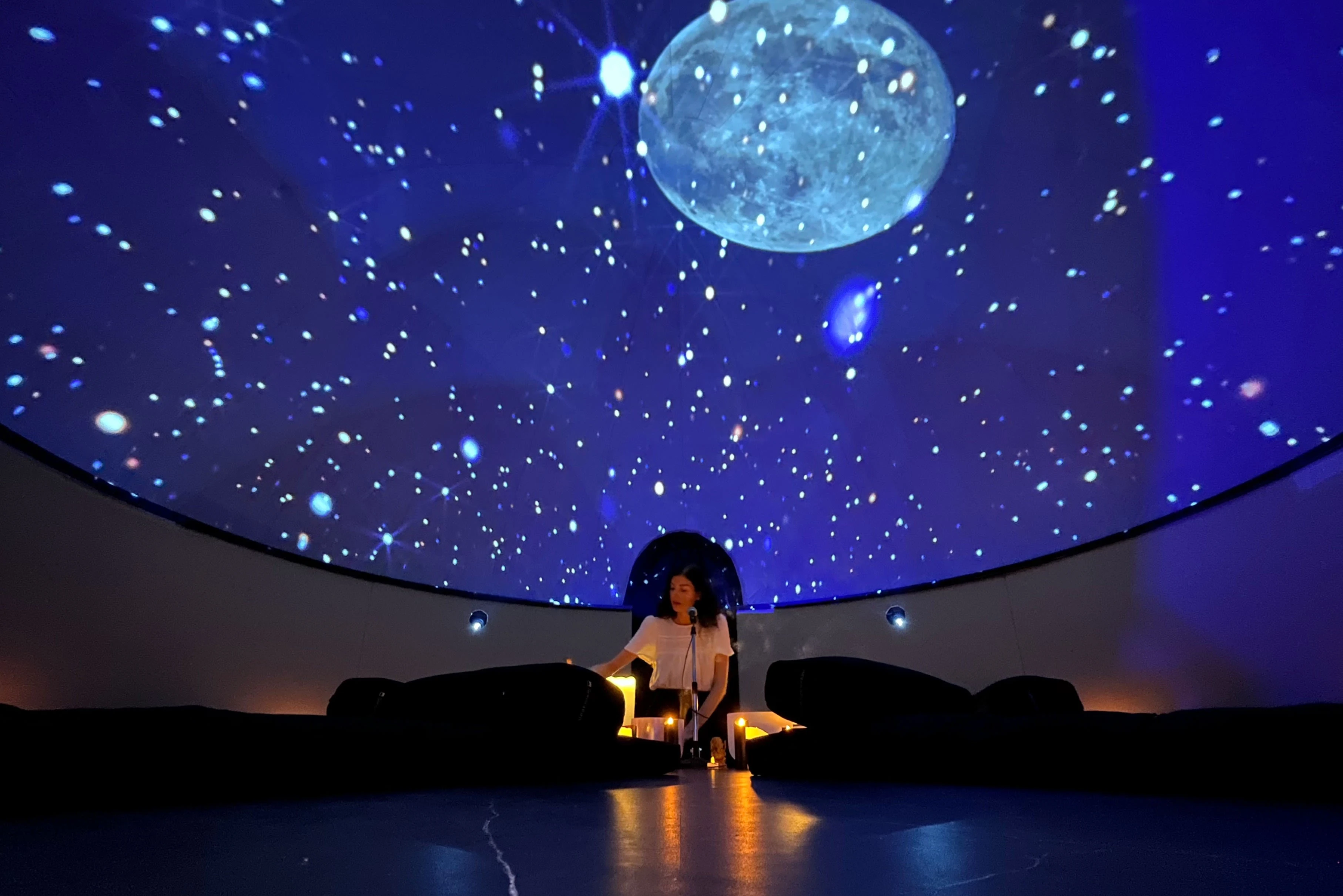Inside the Sensorium dome — starfield projection with seated practitioner